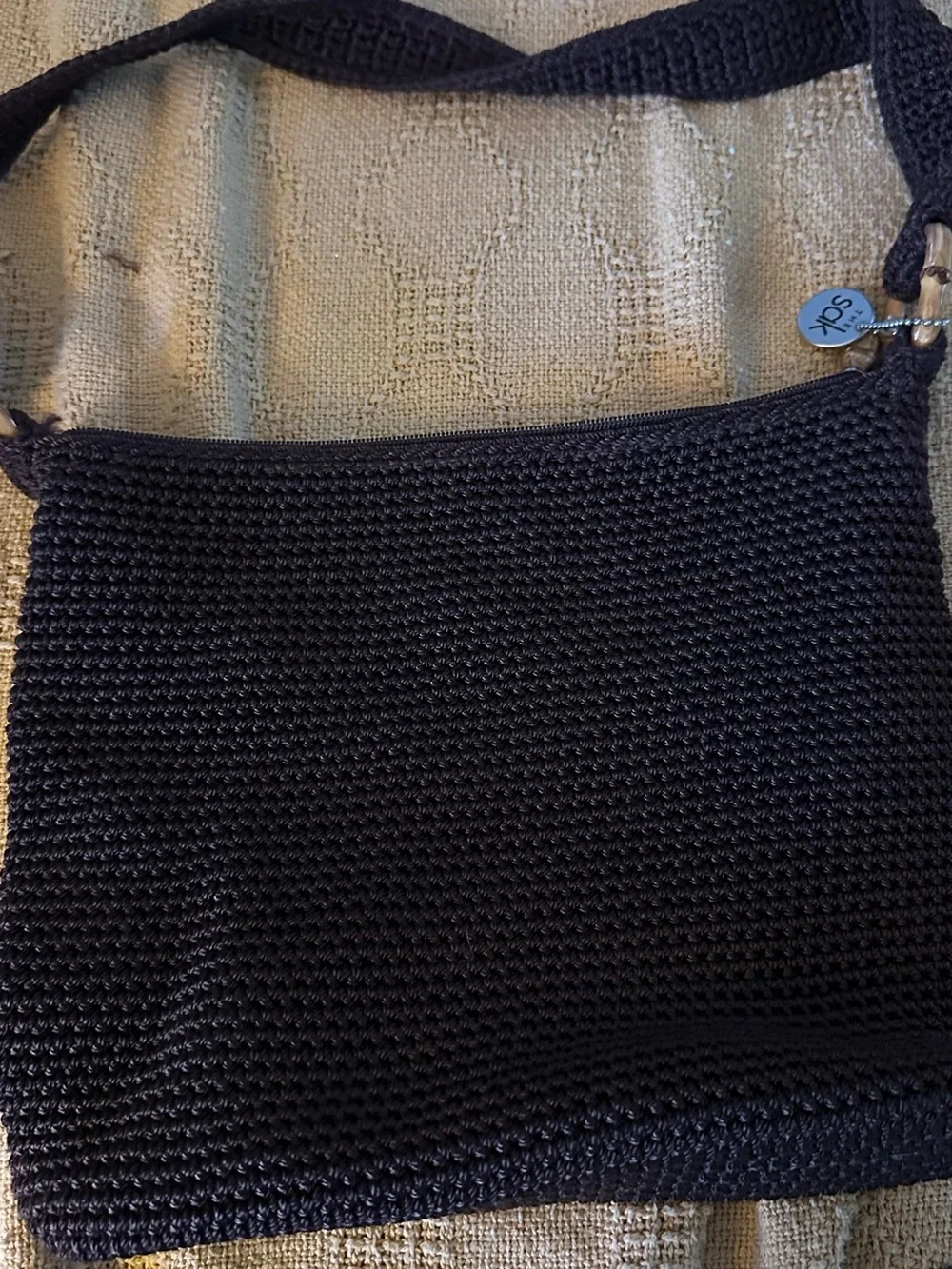 The Sak Bronw Crochet Shoulder Bag with Signature Charm
